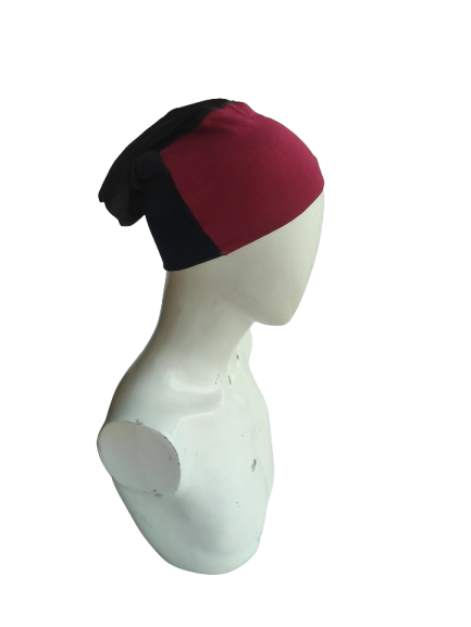 Mannequin head wearing a black and red beanie on a white background