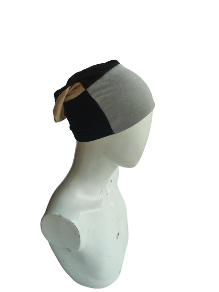 Gray and black headscarf on a mannequin head against a white background