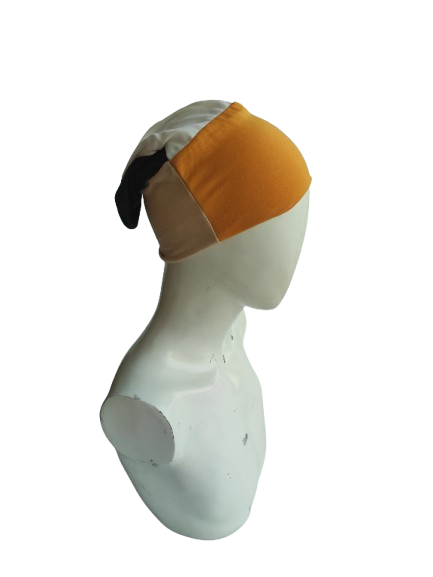Mannequin head with a white and orange headscarf on a white background